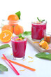 Refreshing healthy beetroot juice with orange and honey for anemia on a white floor, food photography