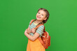 A beautiful little girl with a school bag on an isolated background. A joyful schoolgirl. Copy space.