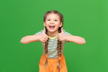 Wall Mural - The joyful girl shows approx. Gives a thumbs up. kid on an isolated background.