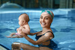 © Pixel-Shot - Cute baby with mother in swimming pool