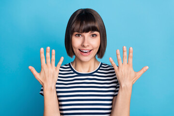 Poster - Photo of cool brunette millennial lady hands up wear striped t-shirt isolated on blue color background