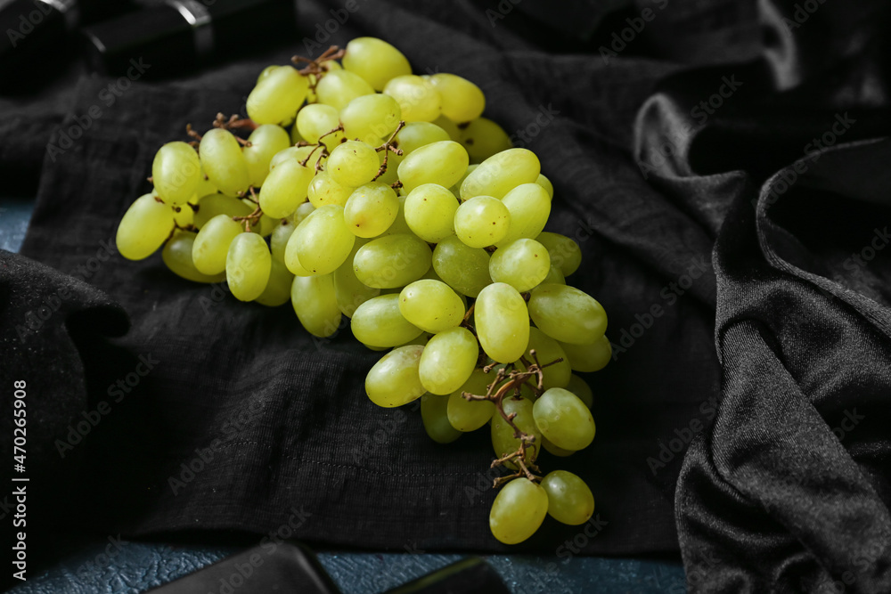 Ripe grapes on black background
