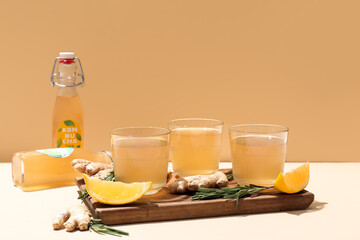 Wall Mural - Glasses of natural kombucha with lemon, ginger and rosemary on table