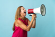 © luismolinero - Middle age brazilian woman isolated on blue background shouting through a megaphone