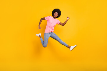 Poster - Full size profile photo of active millennial lady jump wear pink t-shirt jeans isolated on yellow color background