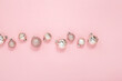 © Alex - Decorative pink shiny balls on a pink background. Top view, flat lay.