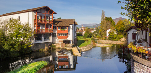 Wall Mural - Panorama of the Nive river in the center of Saint-Jean-Pied-de-Port, France