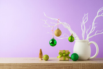 Wall Mural - Christmas holiday background with gift box and  decoration on wooden shelf over violet background.