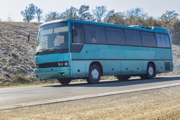 Canvas Print - Tourist bus moves on a country road