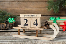 December 24 - Christmas Eve. Wooden Block Calendar And Festive Decor On Table