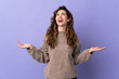 © luismolinero - Young caucasian woman isolated on purple background smiling a lot