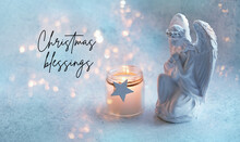 Christmas Blessings Greeting Card. Praying Angel And Candle On Abstract Background With Garland Lights. Faith In God, Christianity Church,  Pray, Lent, Religion Concept. Symbol Of Christmas Holiday.