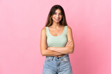 Fototapeta Panele - Young caucasian woman isolated on pink background keeping the arms crossed in frontal position