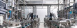 Panoramic photo of gray metal pipes and tanks. Chemistry and medicine production. Pharmaceutical factory. Interior of a high-tech factory, modern production