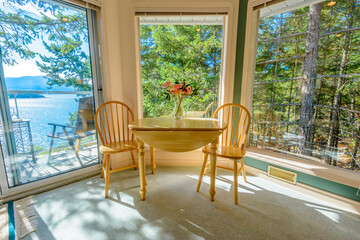 Table with flowers and two chairs. Interior design of a luxury living room.