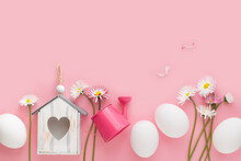 Easter Background With Eggs, Spring Flowers, Birdhouse, Watering Can On Pink Paper