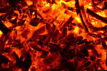 Poster - A mixture of coal and wood burns with an orange fire.