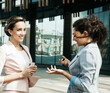 © Raisa Kanareva - Two business women having a casual meeting or discussion near a modern office