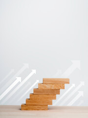 Poster - white rise up arrows with wooden blocks arranged as a steps chart on a wooden desk and clean white b