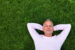 Adult caucasian man rest lying on grass with eyes closed. Copy space.