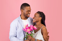 Happy Black Man Making Surprise For Woman Giving Flowers