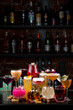 set cocktails on the bar counter against the background of a dark bar vertically