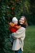 © alas_spb - mother with a baby in her arms on a walk. A woman with a child in nature in the park