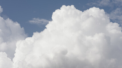 Wall Mural - Puffy white clouds on blue sky