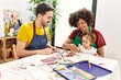 © Krakenimages.com - Couple and daughter smiling confident drawing at art studio