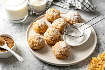 Wall Mural - Homemade coconut cookies in a white plate on a light gray culinary background