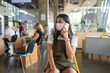 © teksomolika - Young woman in face mask talking on mobile phone at indoor.
