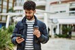 © Krakenimages.com - Young arab man using smartphone outdoor at the town