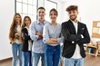 © Krakenimages.com - Group of young business workers smiling happy standing with arms crossed gesture at the office.