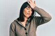 © Krakenimages.com - Young hispanic woman wearing casual clothes surprised with hand on head for mistake, remember error. forgot, bad memory concept.