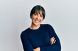 © Krakenimages.com - Young hispanic woman wearing casual clothes happy face smiling with crossed arms looking at the camera. positive person.