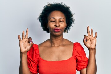 Wall Mural - Young african american woman wearing casual clothes relax and smiling with eyes closed doing meditation gesture with fingers. yoga concept.