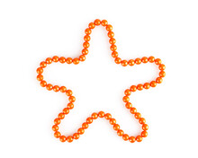 Orange Beads  Lying In The Shape Of A Star Isolated On White Background With Shadow, Top View, Close-up. Decorative Element, Christmas Star.