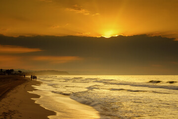 Wall Mural - Sunrise on the naturist beach Els Muntanyans in Torredembarra, Tarragona, Spain