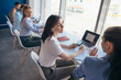 © undrey - Young women sitting at a desk and working in an office