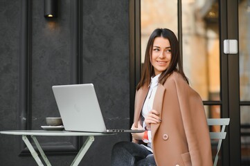 Happy Nice Woman Working on Laptop in Street Cafe