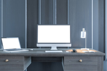 Aufkleber - Modern designer desktop with empty white computer and laptop screens in wooden interior at night. Workplace concept. Mock up, 3D Rendering.