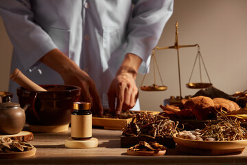 traditional chinese medicine with herb and spices in brown wooden background and a doctor for advert