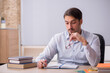 © Elnur - Young male teacher in front of whiteboard