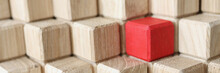 Wooden Cubes Of Beige Color In Middle Of Red Stands In Pyramid