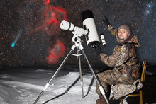 A European Man Is Observing A Comet Through A Telescope.