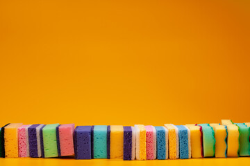 Wall Mural - Stacked household cleaning sponges on yellow background