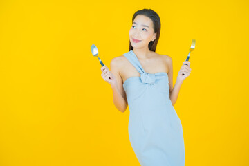 Wall Mural - Portrait beautiful young asian woman smile with spoon and fork