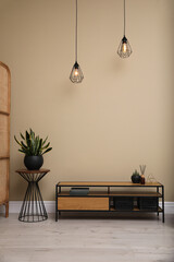 Poster - modern cabinet and green plants near beige wall in room. interior design