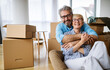 © NDABCREATIVITY - Portrait of happy senior couple in love moving in new home
