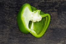 Green Bell Pepper Half, Cut Lengthwise Lies On Dark Surface